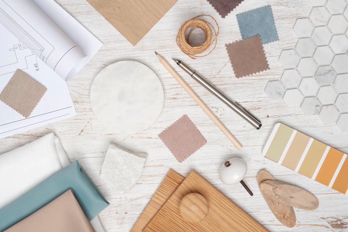 Overhead view of a designer's desk with fabric and material samples